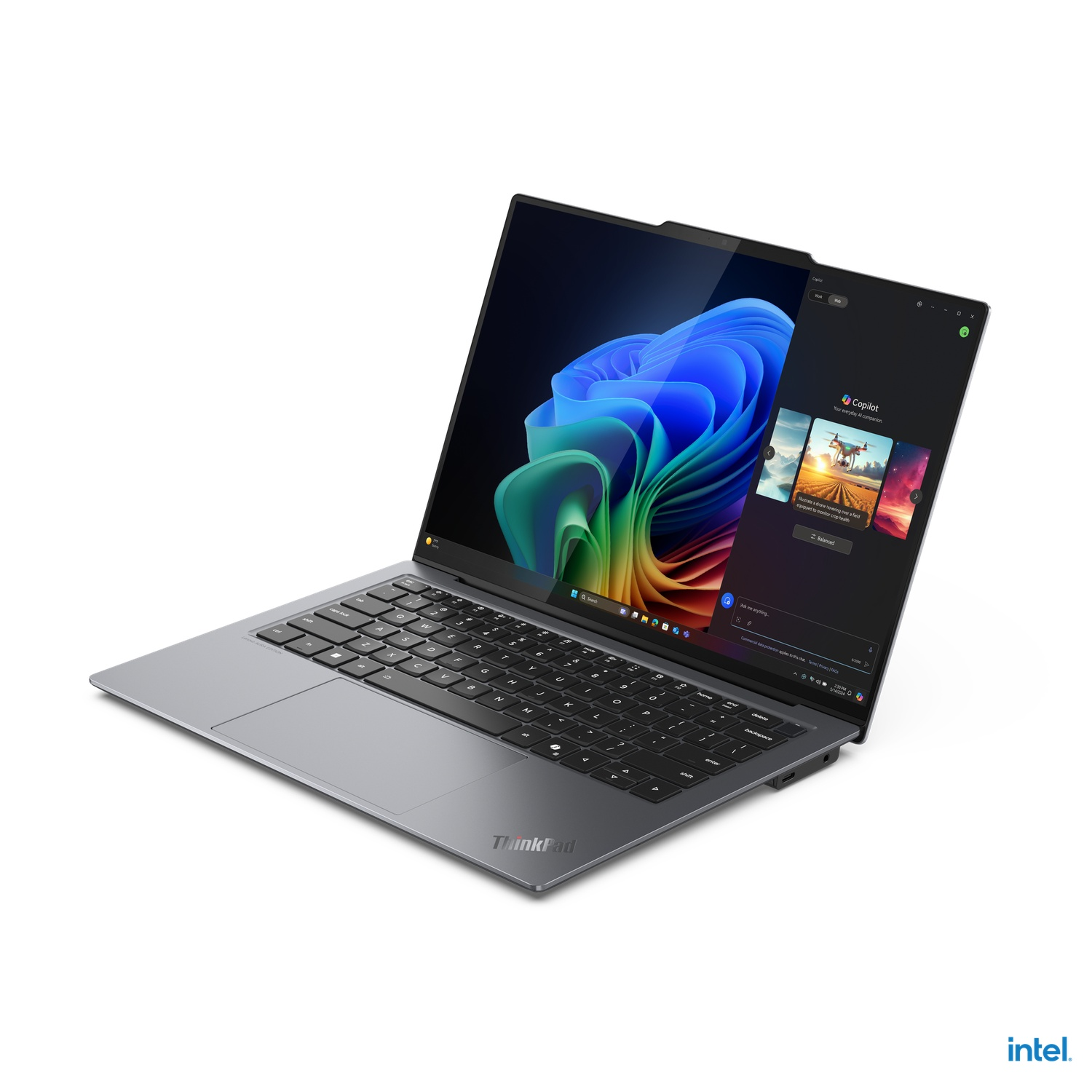 Open laptop with a colorful screen, keyboard visible. 'ThinkPad' and 'intel' logos are present.