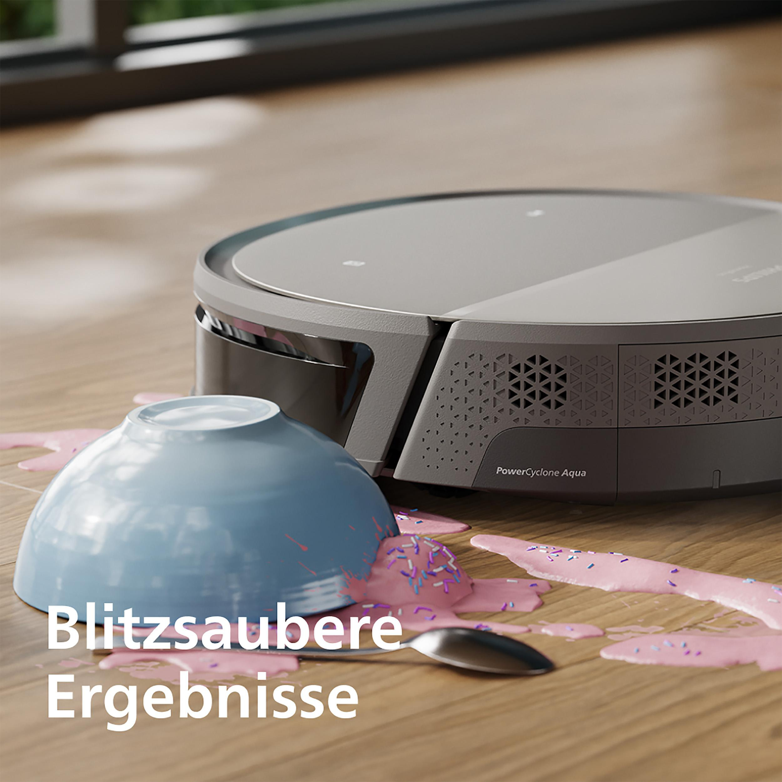 Ein Roboterstaubsauger mit einer verschütteten Schüssel rosa Müsli auf Holzboden.