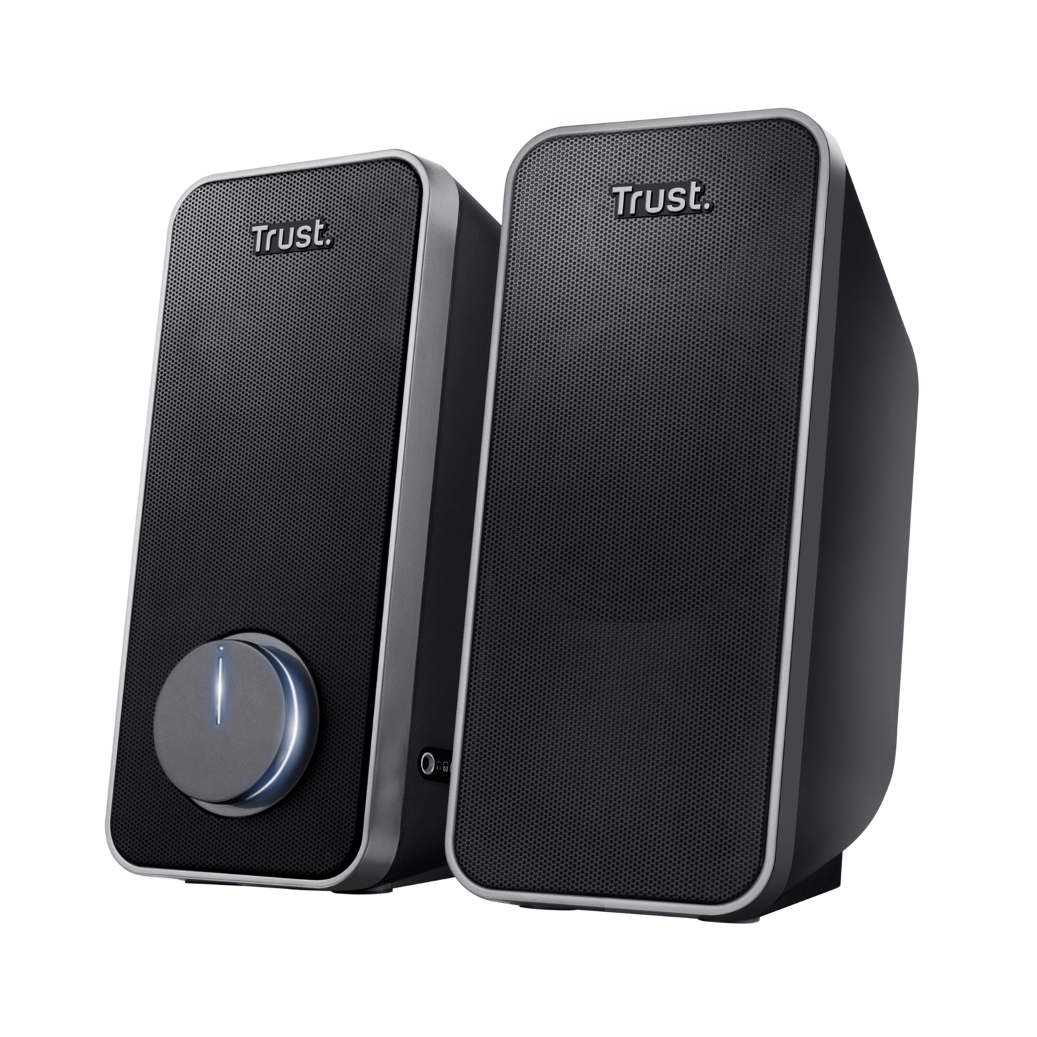 Two black Trust speakers with silver trim. A blue light is on the volume knob of one speaker.
