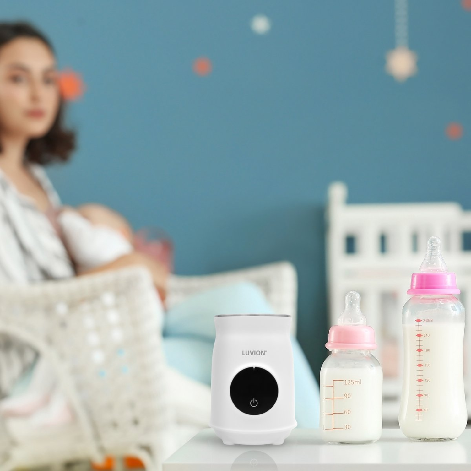 Baby bottles, a warmer, and a woman breastfeeding.
