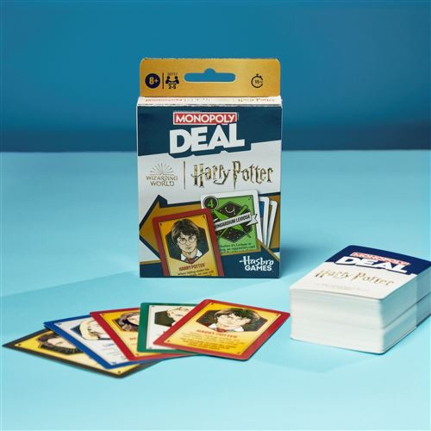 Monopoly Deal card game, Harry Potter design, box and cards on blue background.