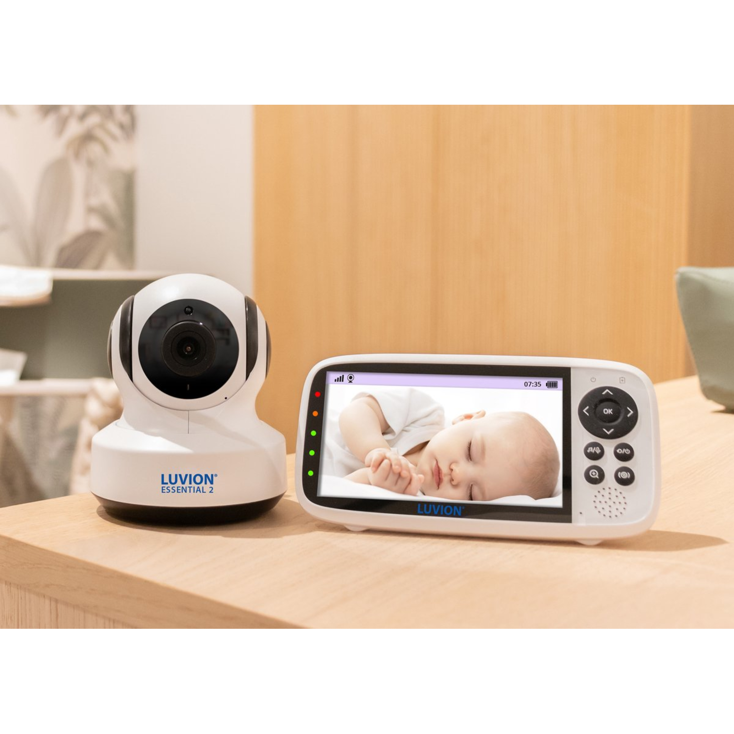 Luvion Essential 2 baby monitor set with a baby sleeping on screen.