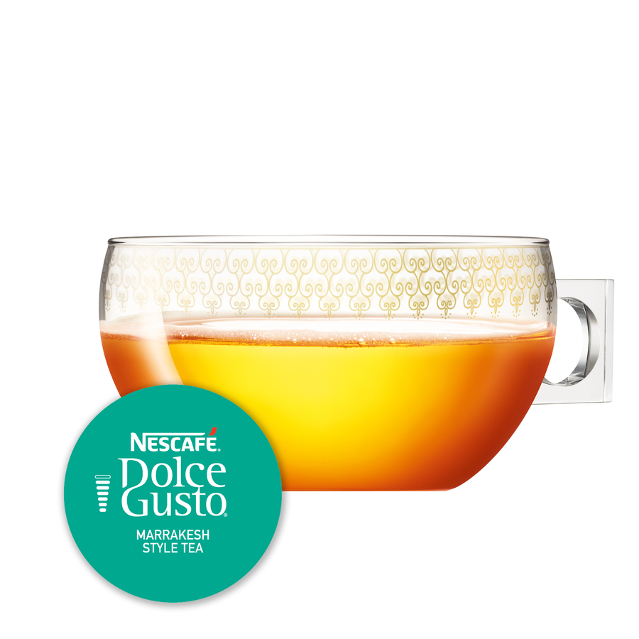 Una taza de té de vidrio con un logotipo de Nescafe Dolce Gusto en una etiqueta redonda.