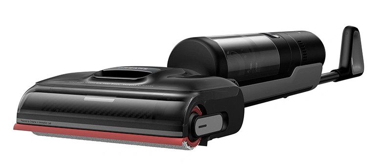Czarny i czerwony odkurzacz robot. Ma długi uchwyt i pojemnik na kurz.