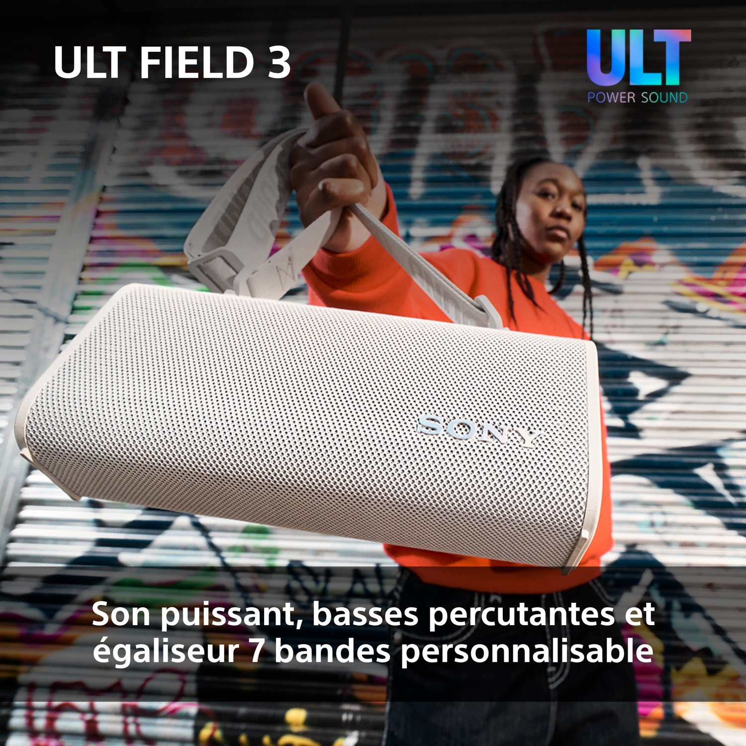 Une personne tient un haut-parleur blanc Sony. L'arrière-plan montre du graffiti. Le texte dit : ULT FIELD 3. ULT POWER SOUND.