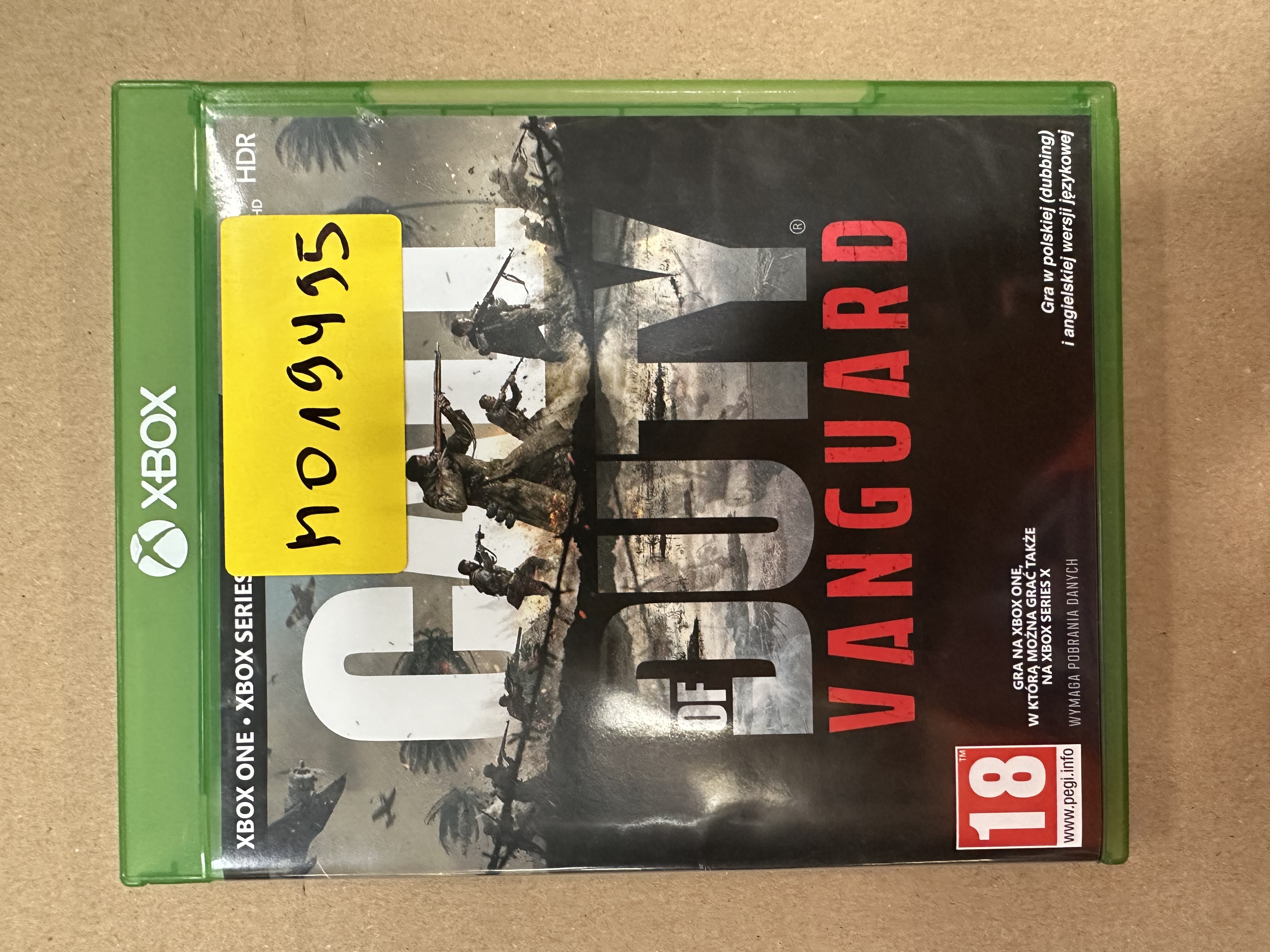 Górna część obudowy gry Xbox, zielona z żółtą naklejką. Tytuł gry jest widoczny.