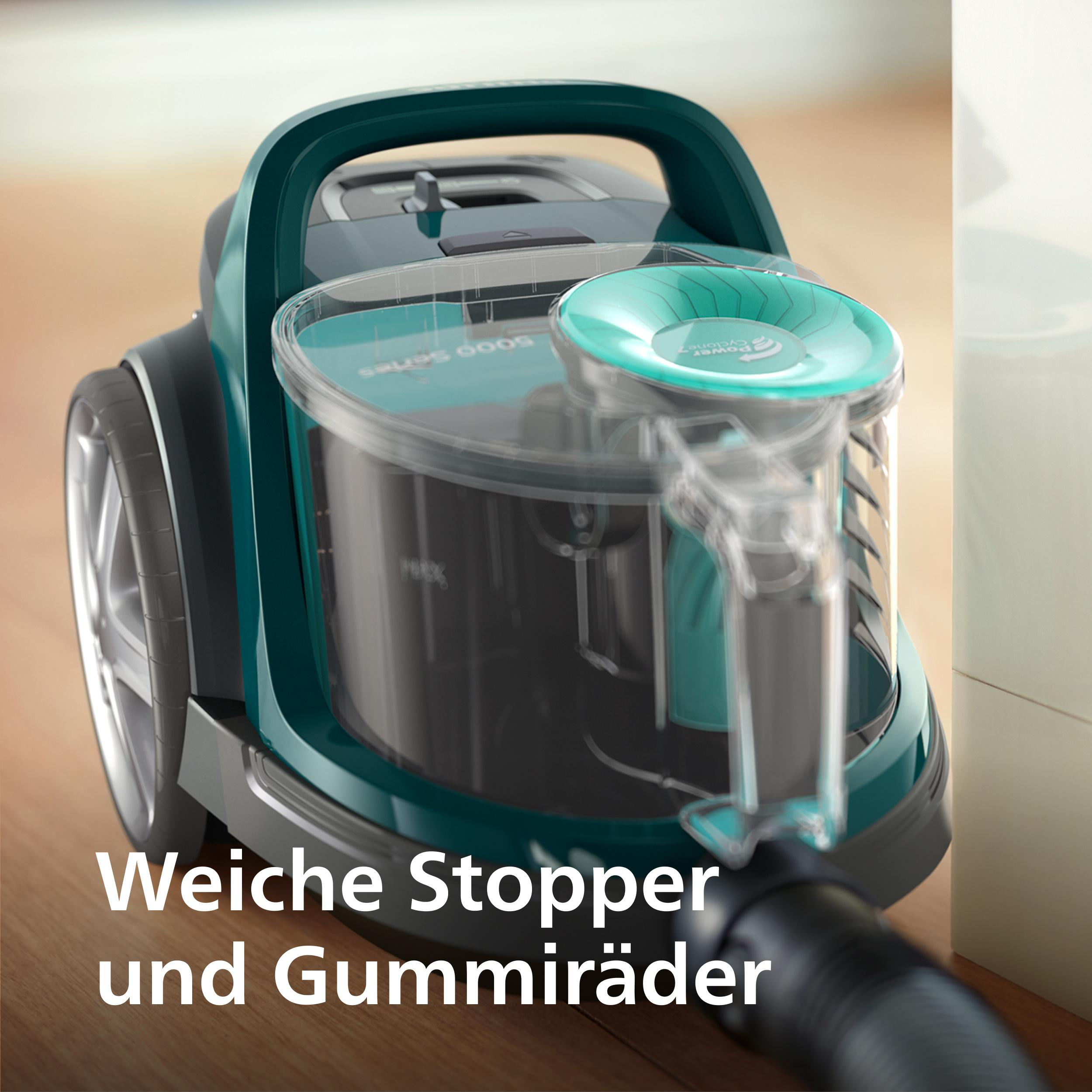 Ein Staubsauger mit deutschem Text. Der Fokus liegt auf dem durchsichtigen Behälter.