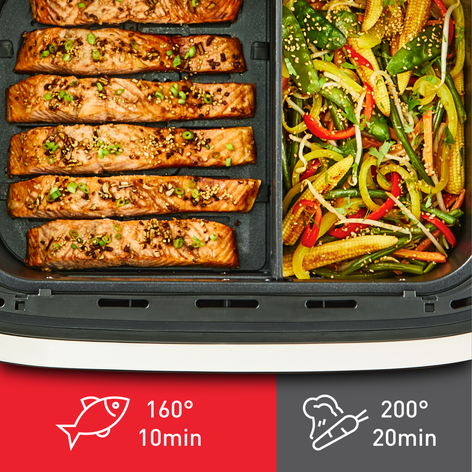 A black air fryer tray with salmon and vegetables, with cooking instructions.