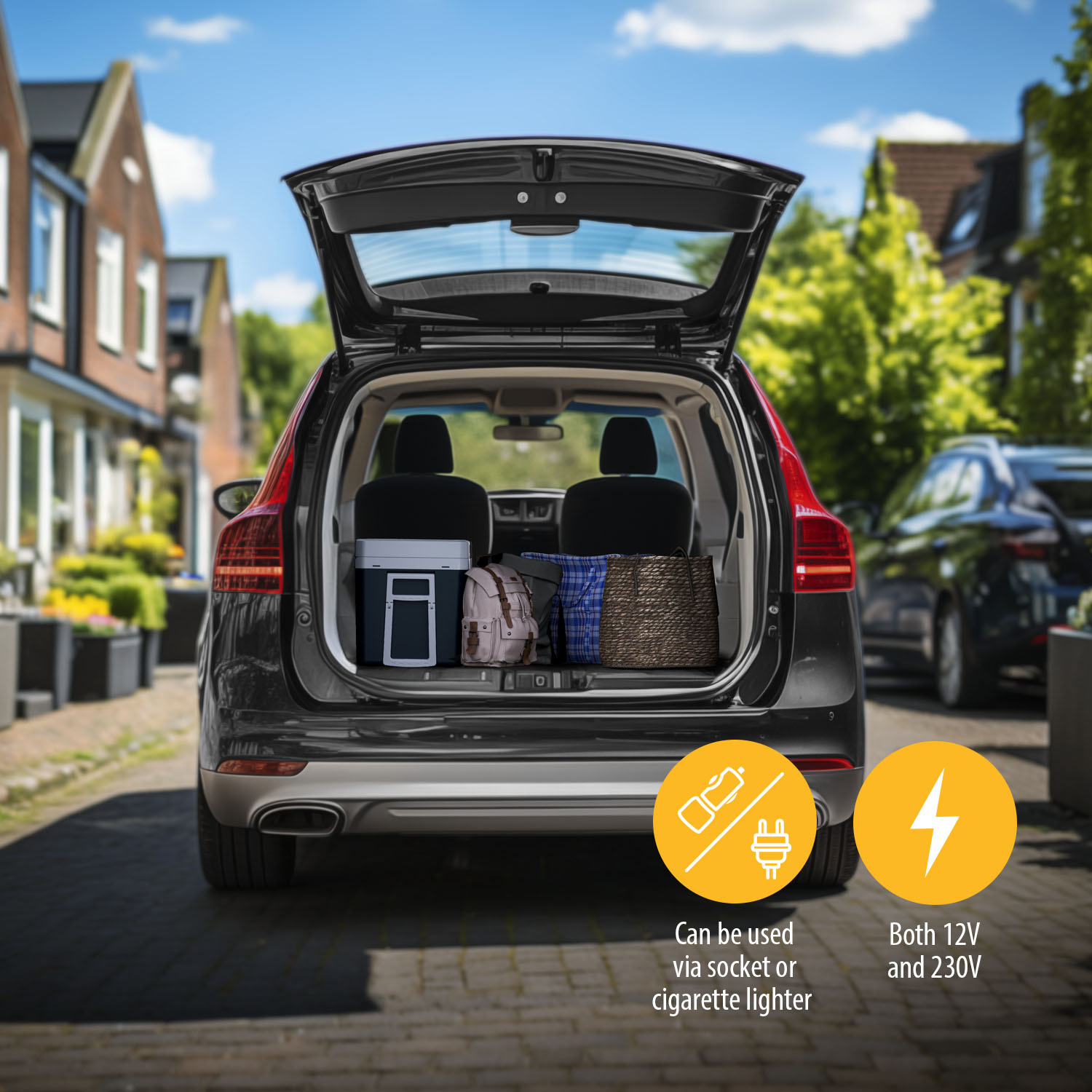 Open car trunk with luggage: cooler, backpack, basket. Car parked on street. Blue sky and houses in the background.