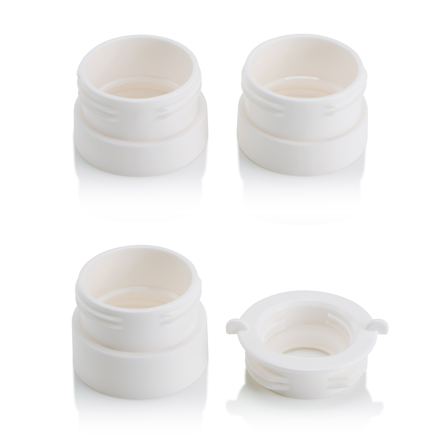 Four white plastic containers, top view, on a white surface.
