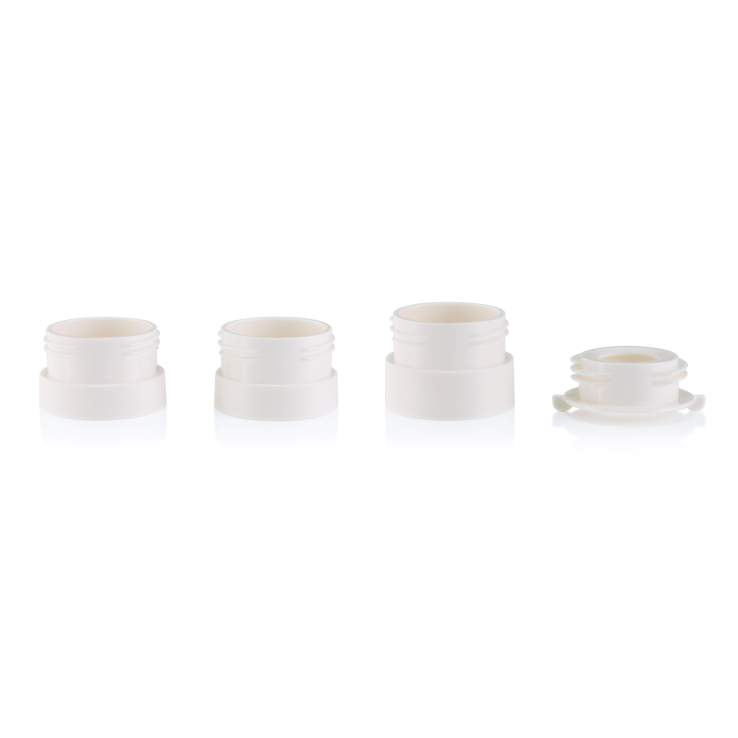 Four white plastic cylindrical objects, three upright and one upside down.