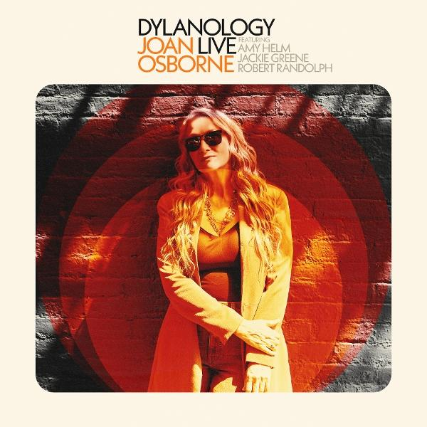 Albumcover mit Joan Osborne. Rotes und oranges Kreisdesign vor Backsteinmauer.