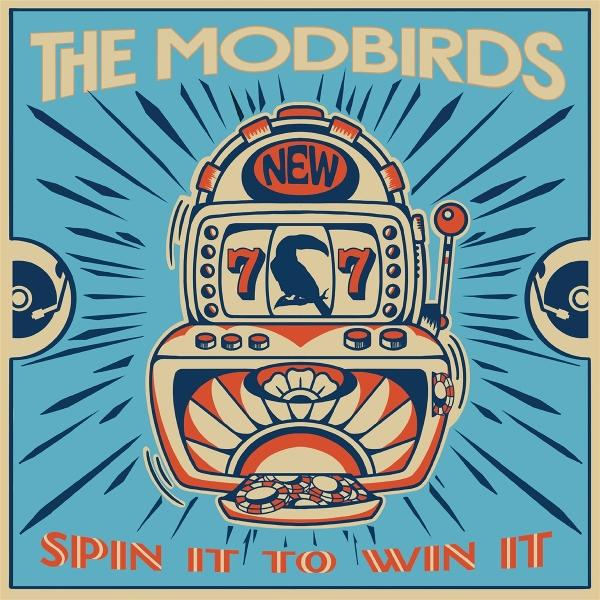 Albumcover mit Spielautomaten-Design. Enthält 'The Modbirds' und 'Spin It to Win It'. Blau und orange Farben.