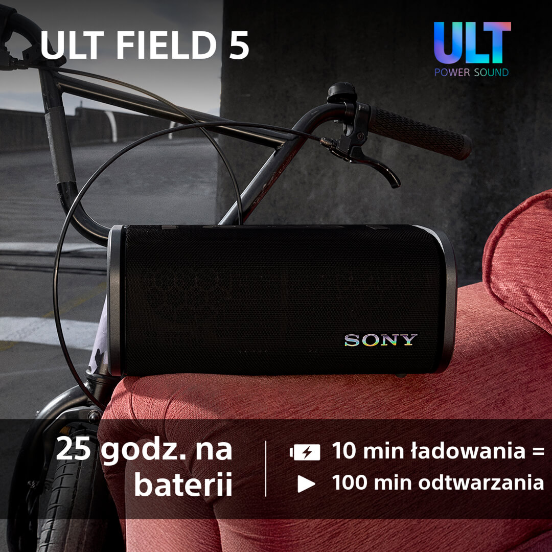 Czarny głośnik na rowerze. Tekst o baterii i czasie odtwarzania. Czerwona powierzchnia.