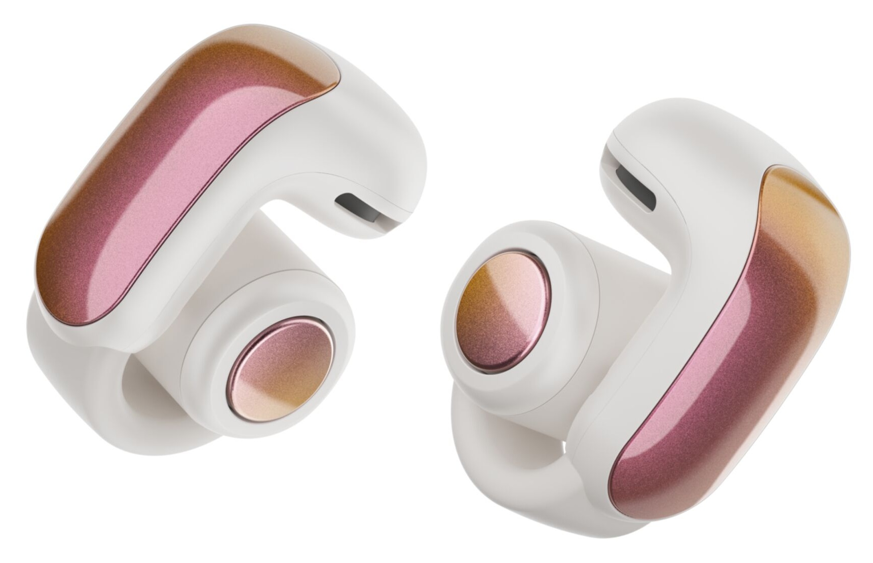 Dwa bezprzewodowe słuchawki. Są białe z różowymi i złotymi akcentami. Widok pod kątem.