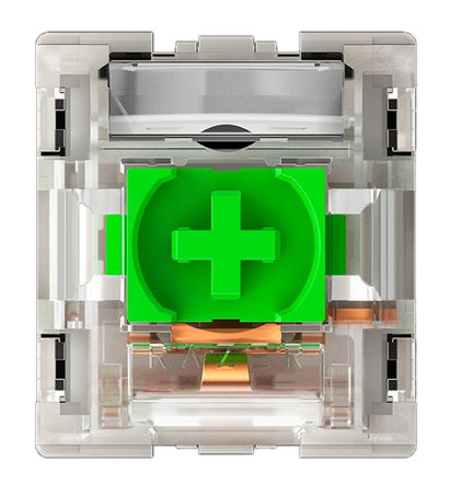 Zbliżenie przełącznika klawiatury mechanicznej. Zielony trzpień w kształcie krzyża jest widoczny wewnątrz przezroczystej plastikowej obudowy.