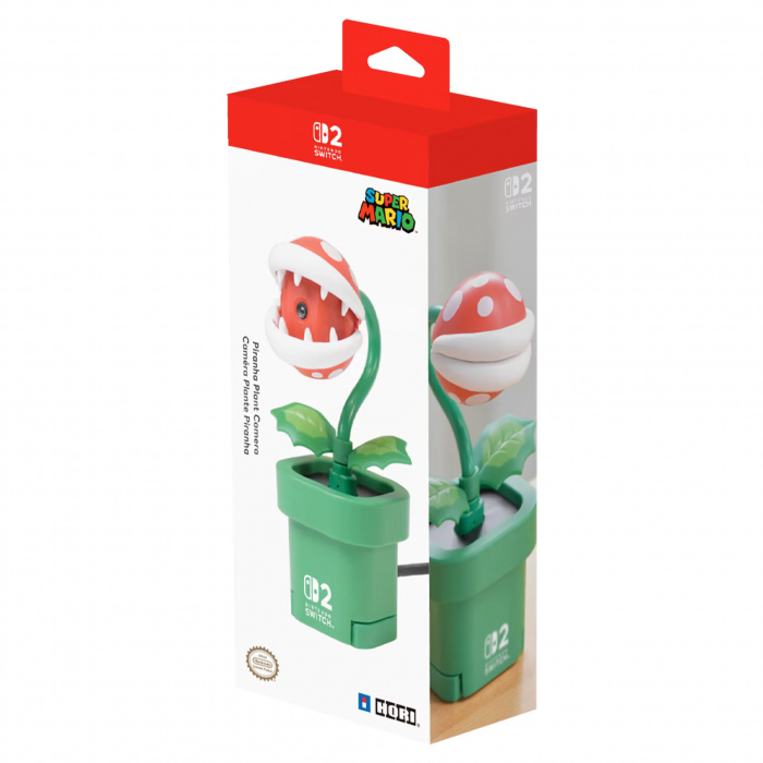 Zapakowana zabawka Super Mario Piranha Plant Camera z czerwoną i białą głową, zieloną rośliną i doniczką.