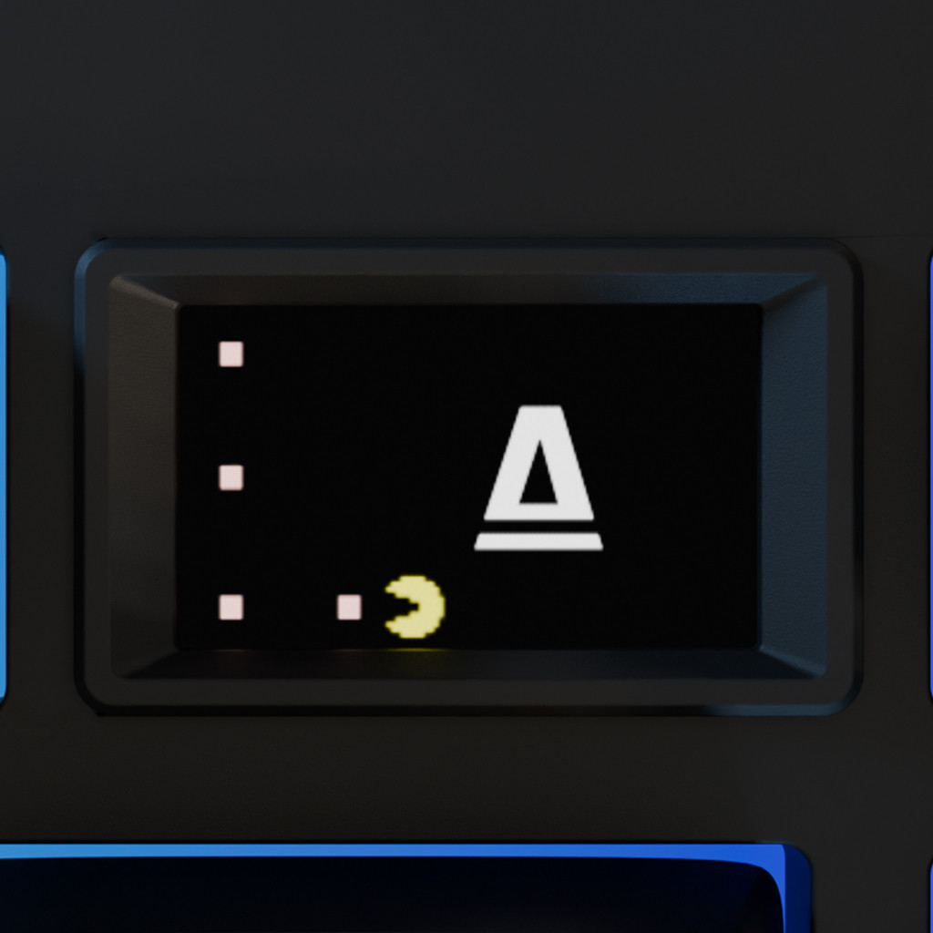 Billentyűzet gombjának közeli képe Pac-Man-nel és az 'A' betűvel.