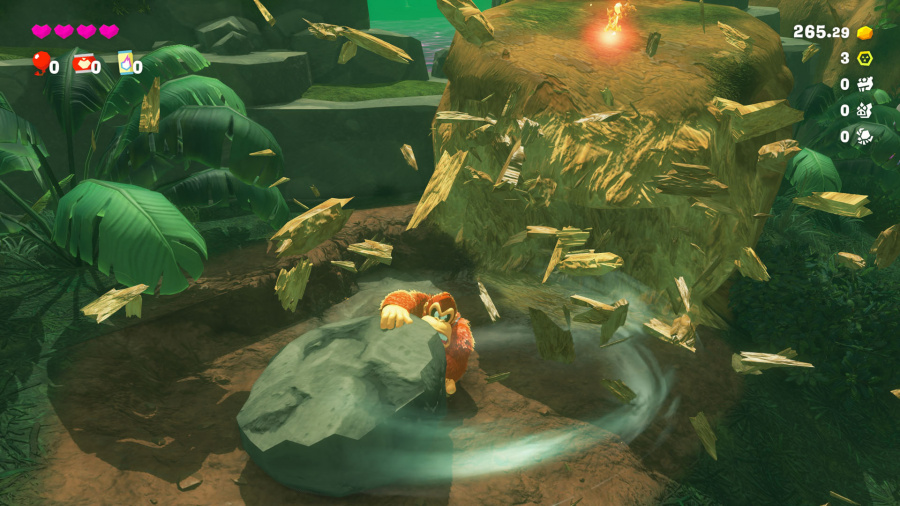 Postać z kreskówki w dżungli, walcząca ze skałą, otoczona gruzem.