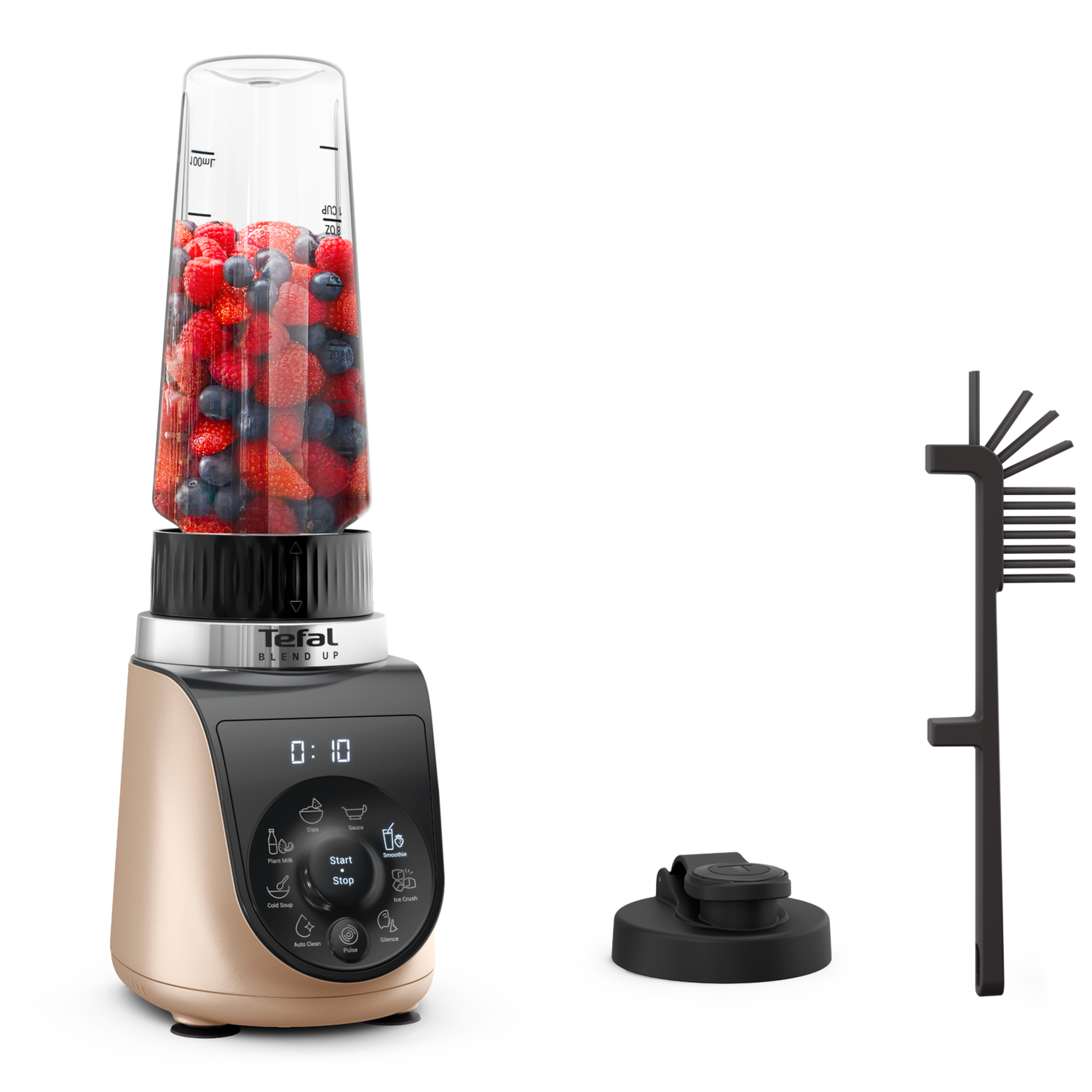 A blender with berries inside. Gold base, black top. Accessories are present. White background.