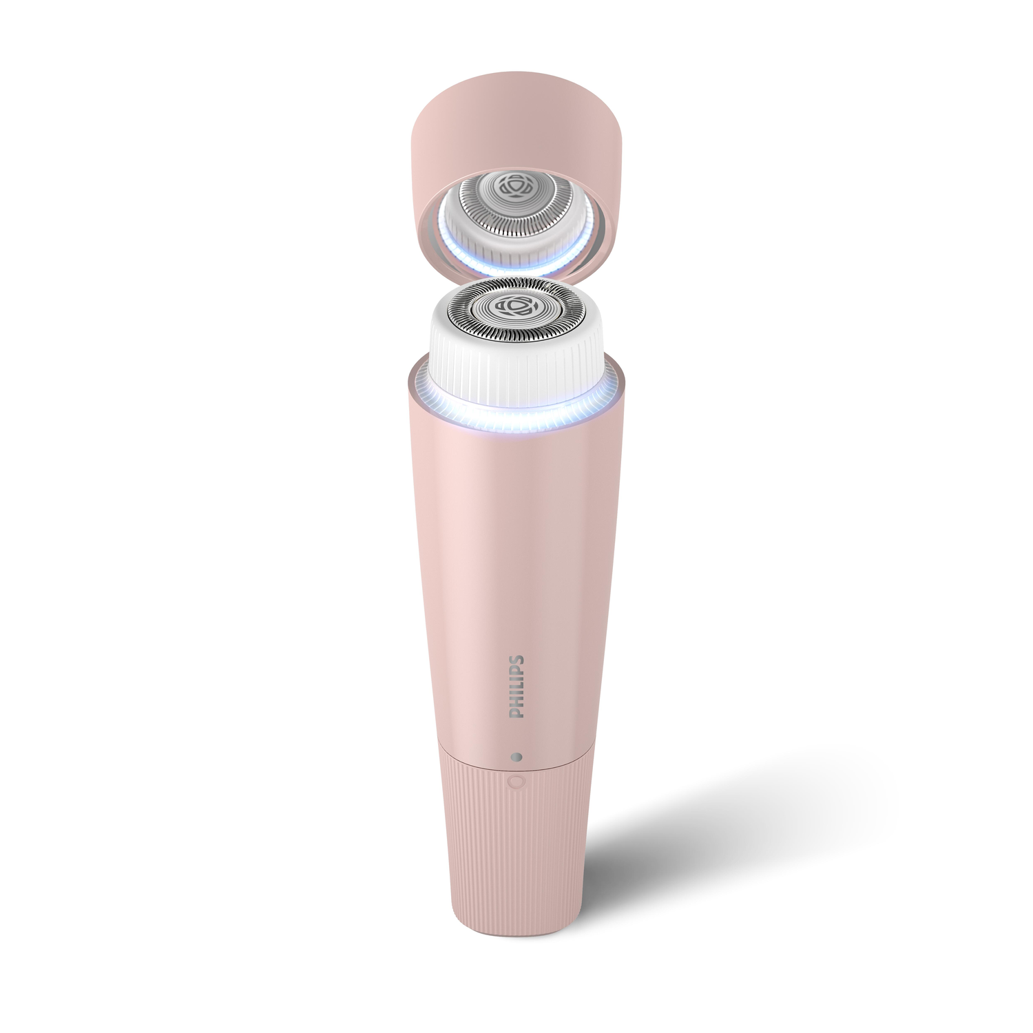 Roze elektrisch scheerapparaat, open, met de mesjes zichtbaar. Witte achtergrond.