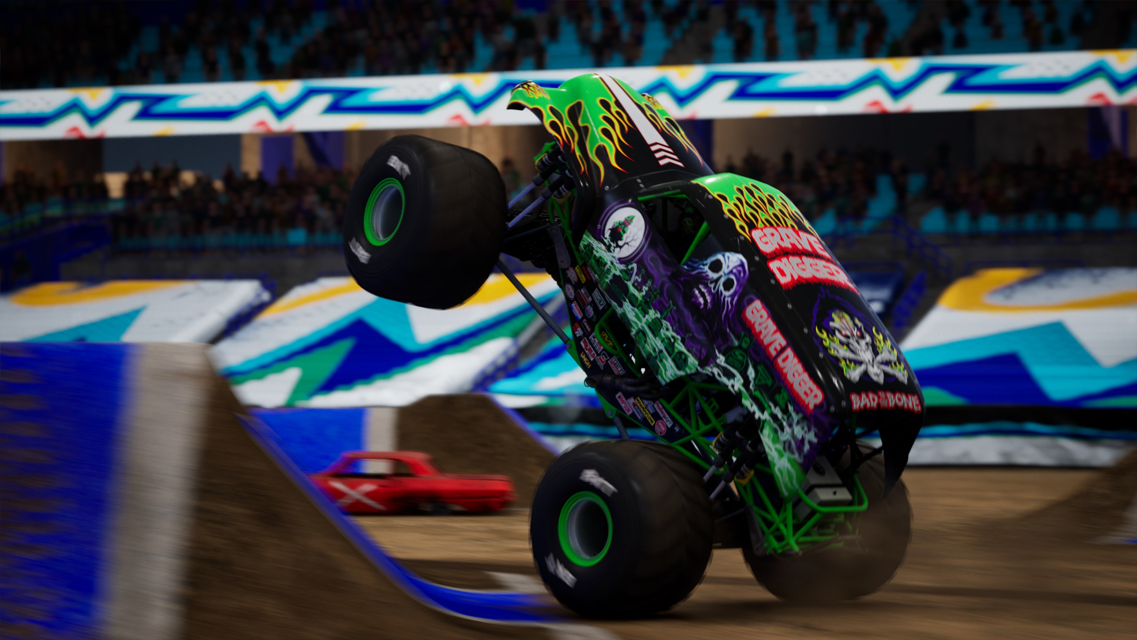 Monster truck Grave Digger a mezz'aria durante una gara in un'arena.