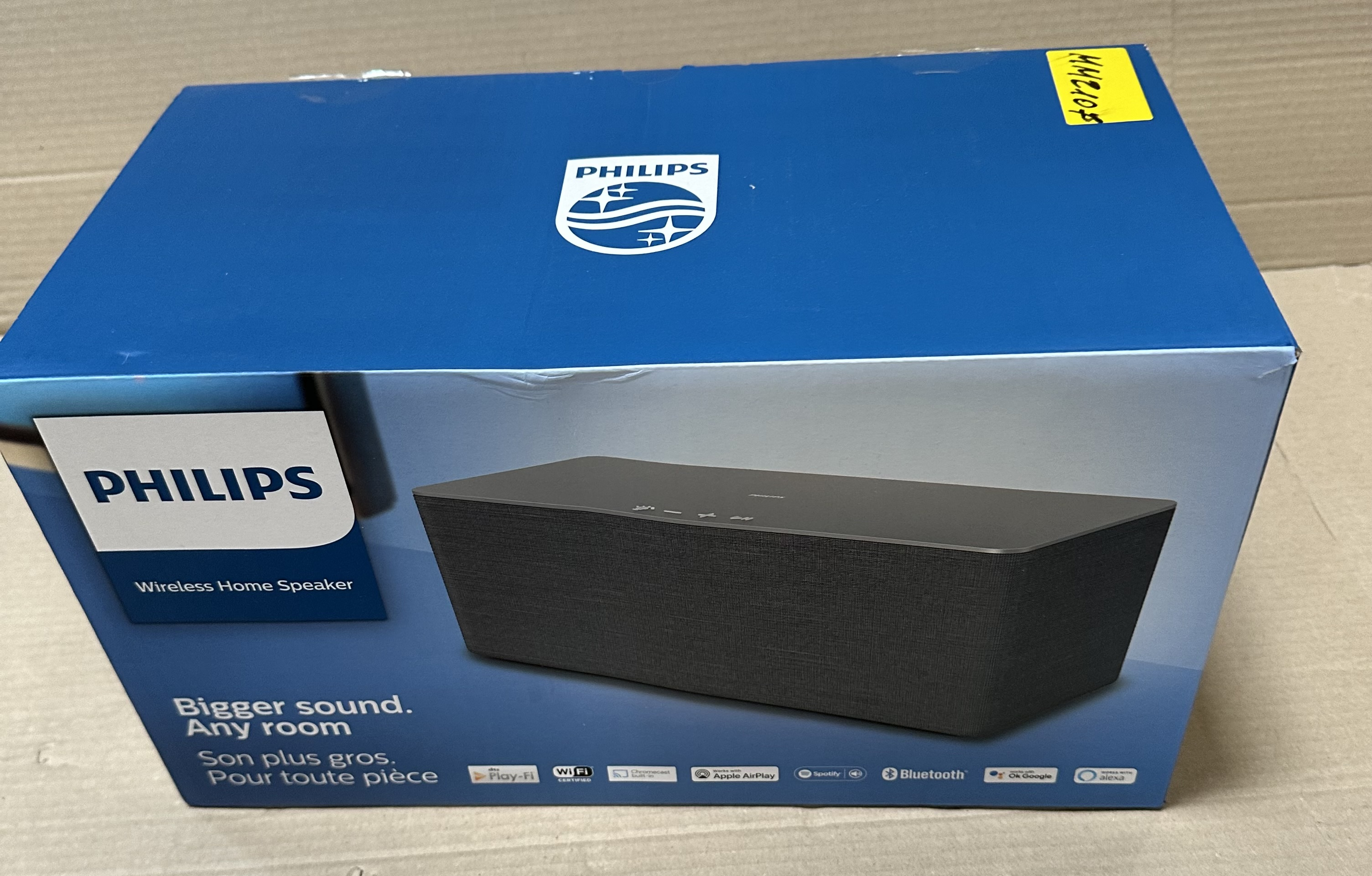 Niebieskie pudełko z logo Philips i czarnym głośnikiem w środku.