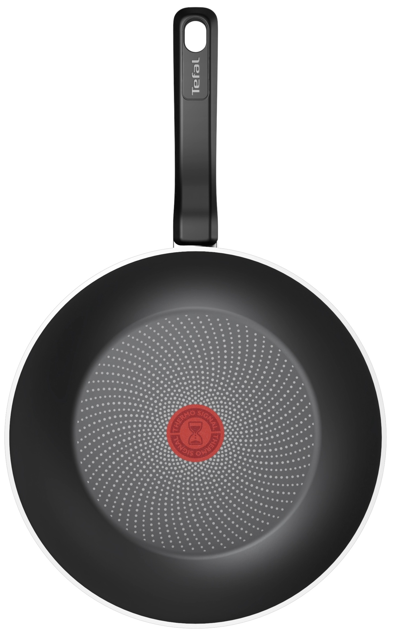 Widok z góry czarnej patelni z czerwonym, okrągłym środkiem.