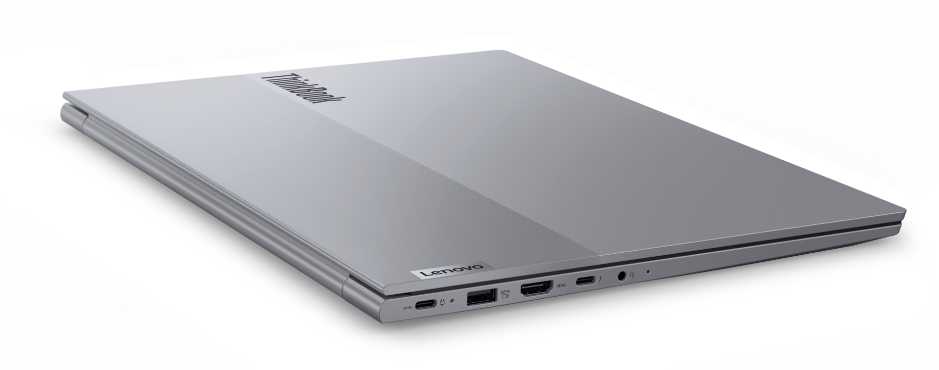 Srebrny laptop, ThinkBook, zamknięty na czarnej powierzchni.