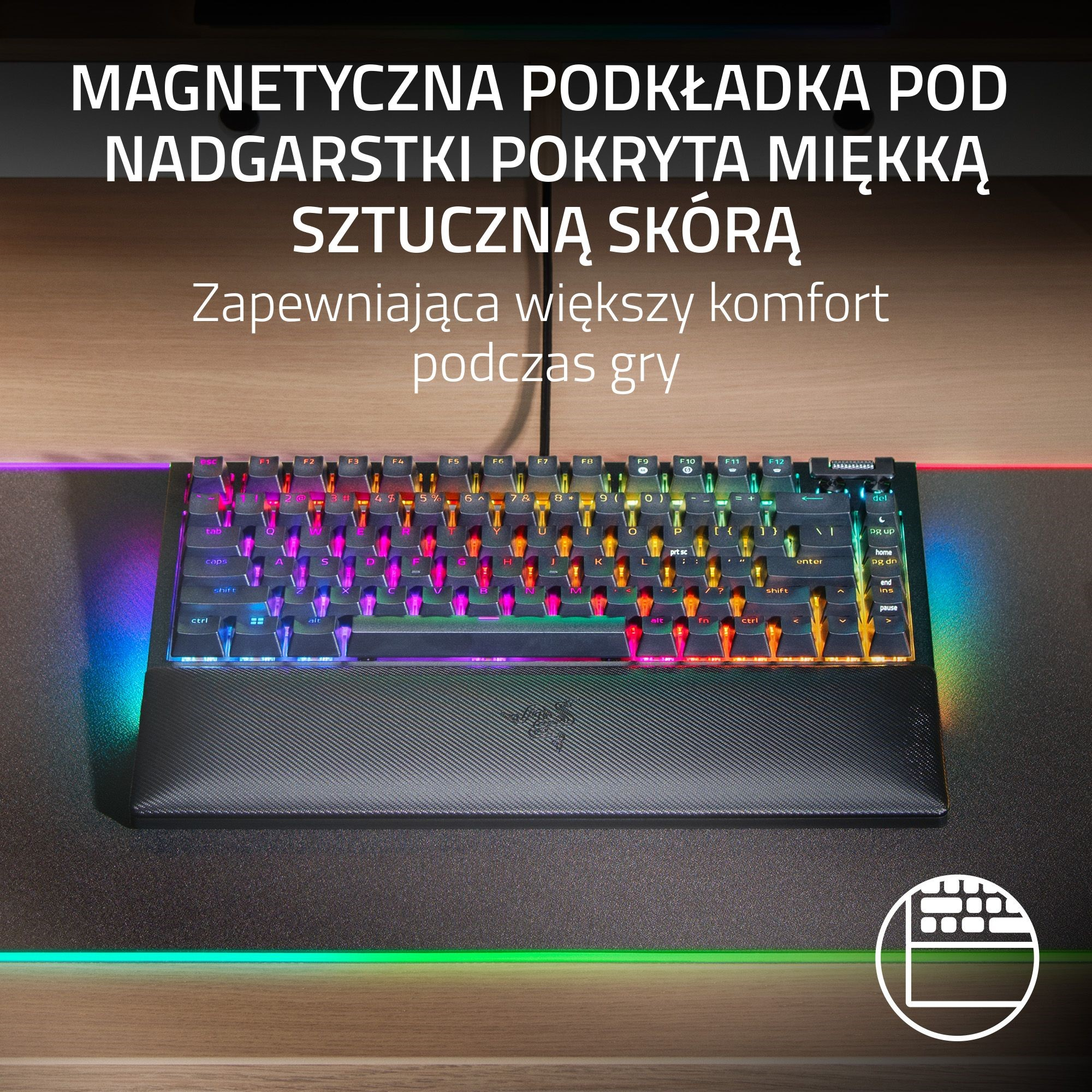 Klawiatura z magnetyczną podpórką pod nadgarstek, z kolorowymi światłami na stole.