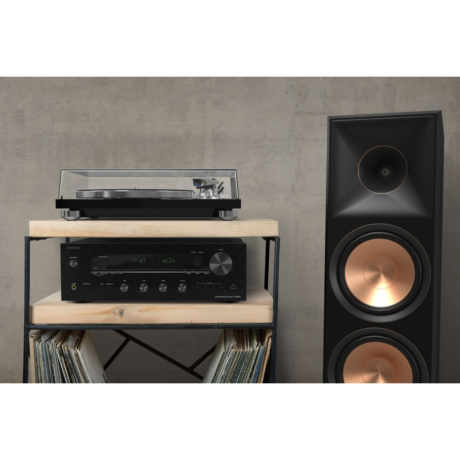A stereo system with a turntable, a receiver, and a speaker. The setup is on a wooden shelf.