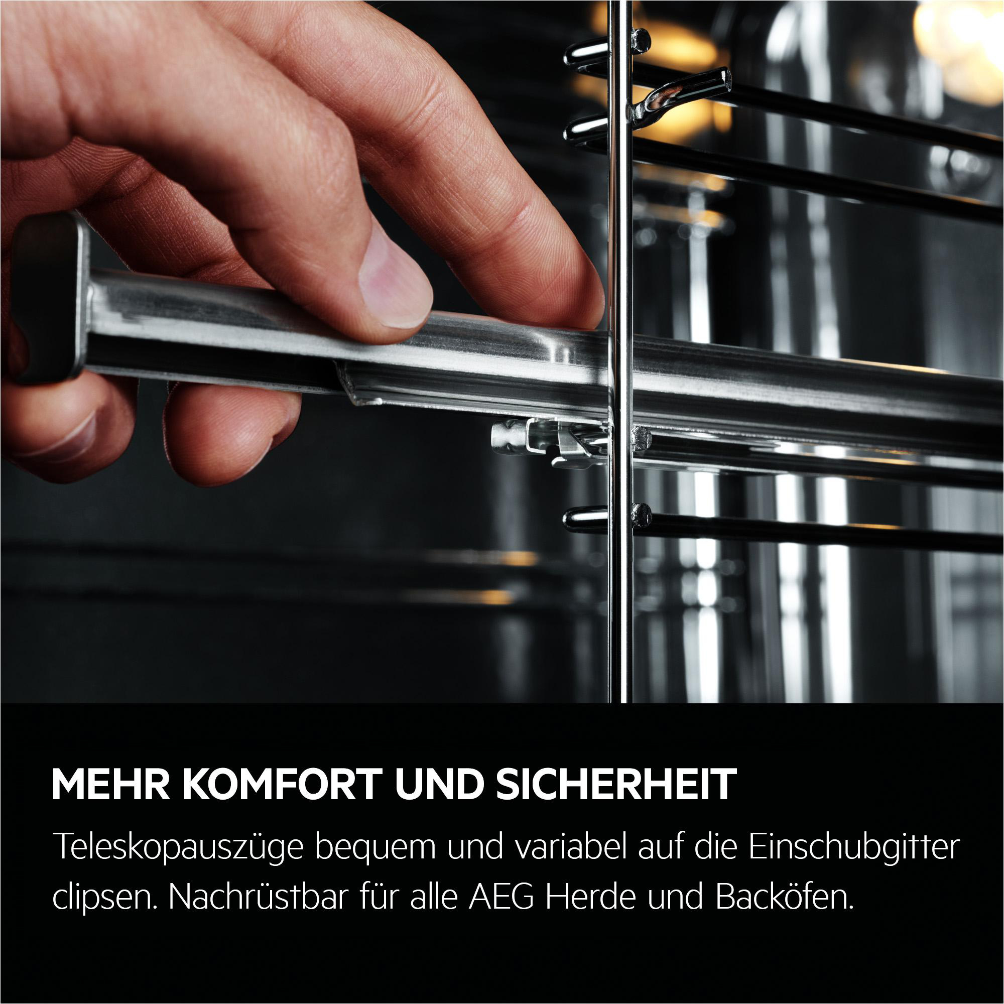 Eine Hand, die einen Metallrost in einen Backofeninnenraum einsetzt. Der Rost ist metallisch, der Innenraum ist dunkel.