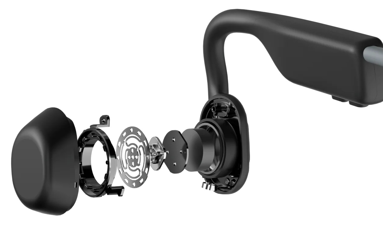 Widok rozłożony czarnych słuchawek kostnych, pokazujący elementy wewnętrzne.