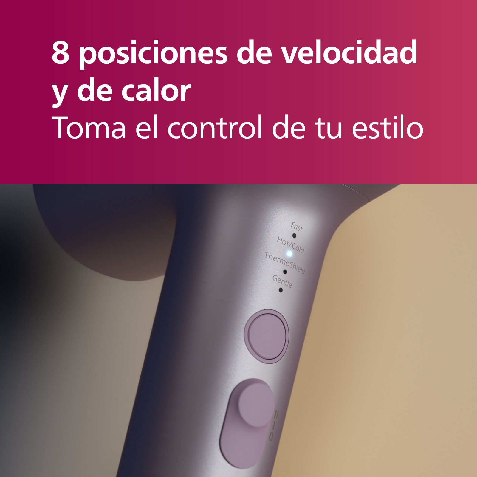 Secador de pelo, primer plano, con ajustes de velocidad y calor y un botón rosa.