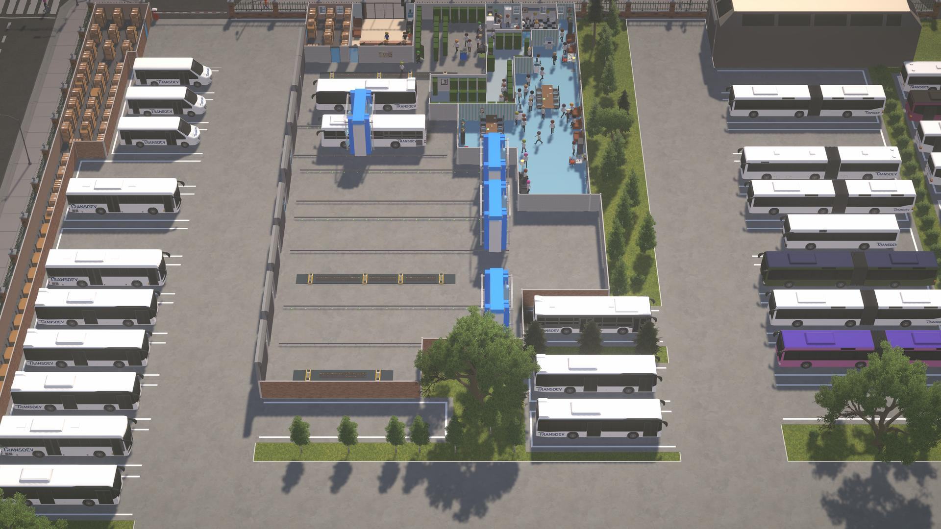 Vogelperspektive eines Busdepots. Busse sind geparkt, und Menschen gehen durch einen Bereich.