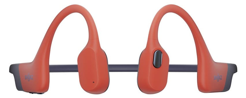 Pomarańczowa para słuchawek przewodnictwa kostnego Shokz, na białym tle.