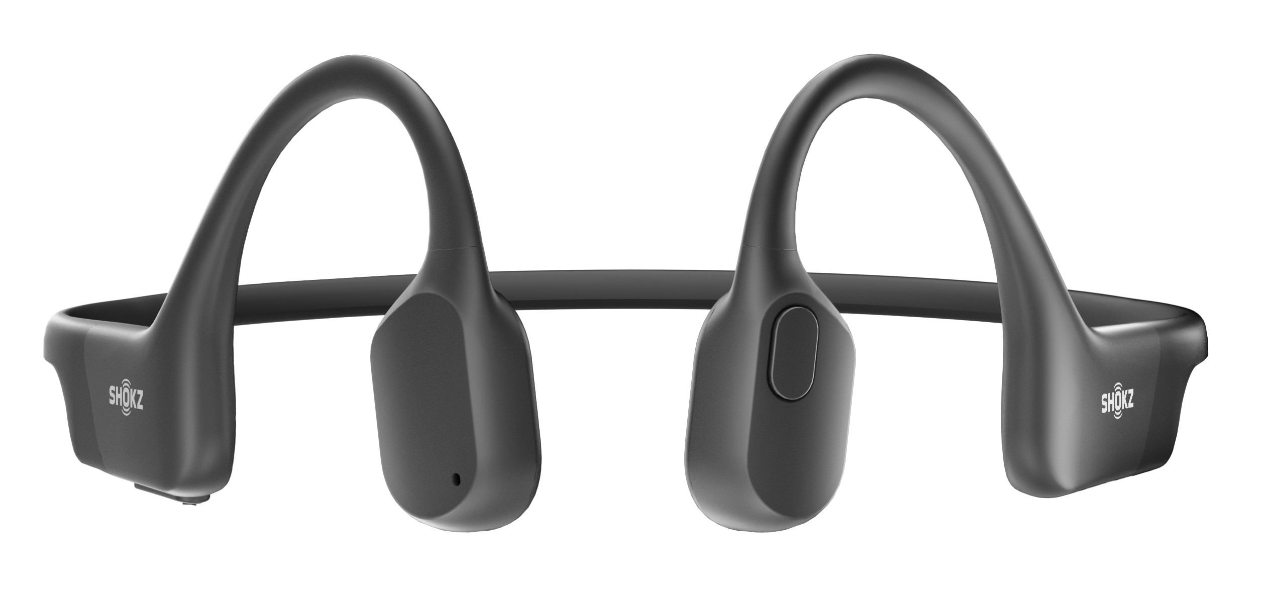 Czarne słuchawki przewodnictwa kostnego. Zakrzywiona konstrukcja, spoczywają na uszach. Białe tło.