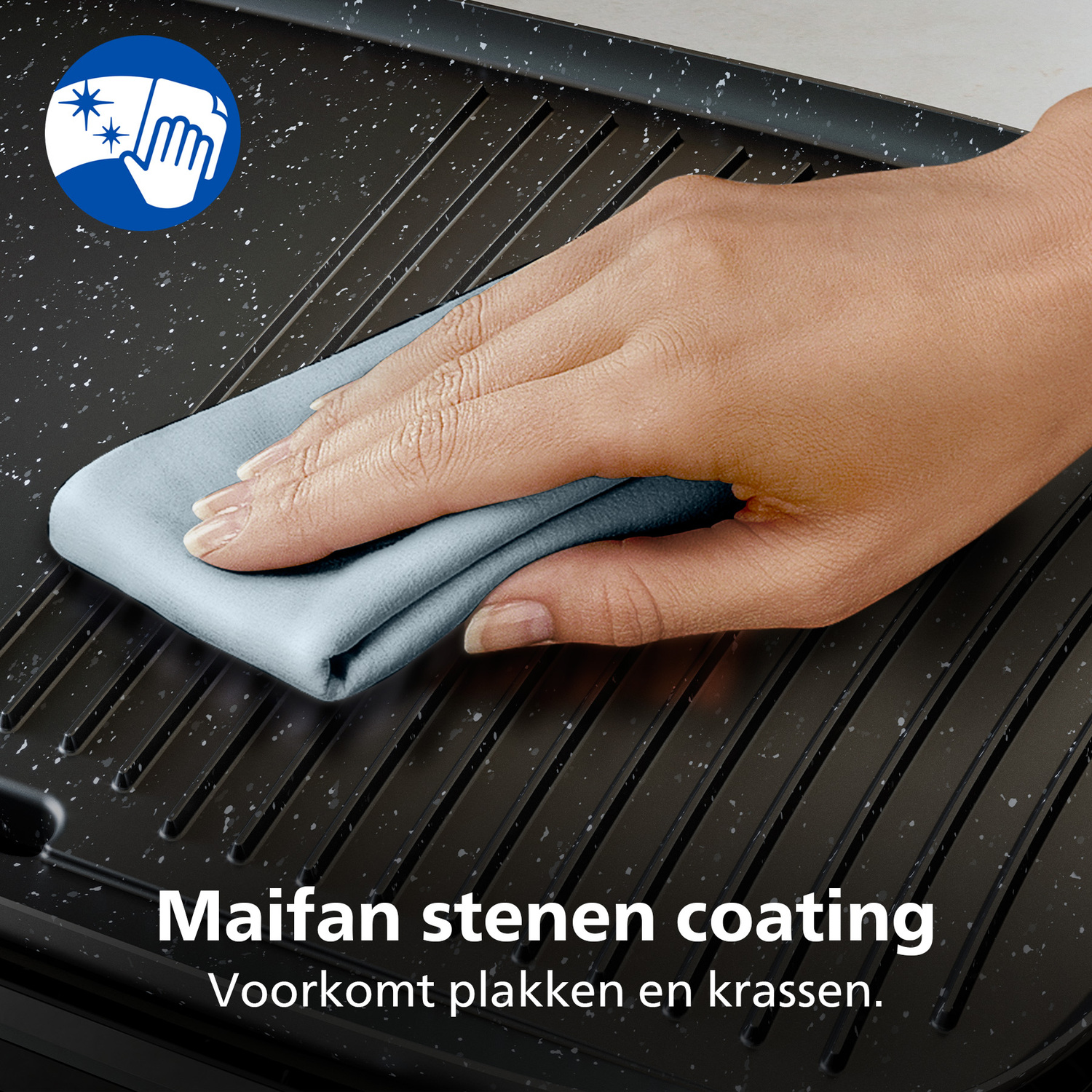 A hand wipes a black grill with a blue cloth. White specks are on the grill. Text says 'Maifan stone coating'.