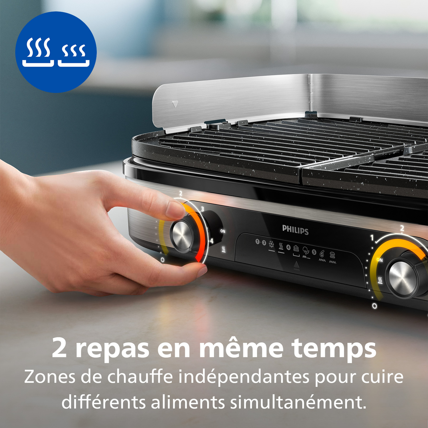 Une main ajuste le cadran d'un grill Philips. Texte : '2 repas en même temps'. Le grill est noir et argenté.