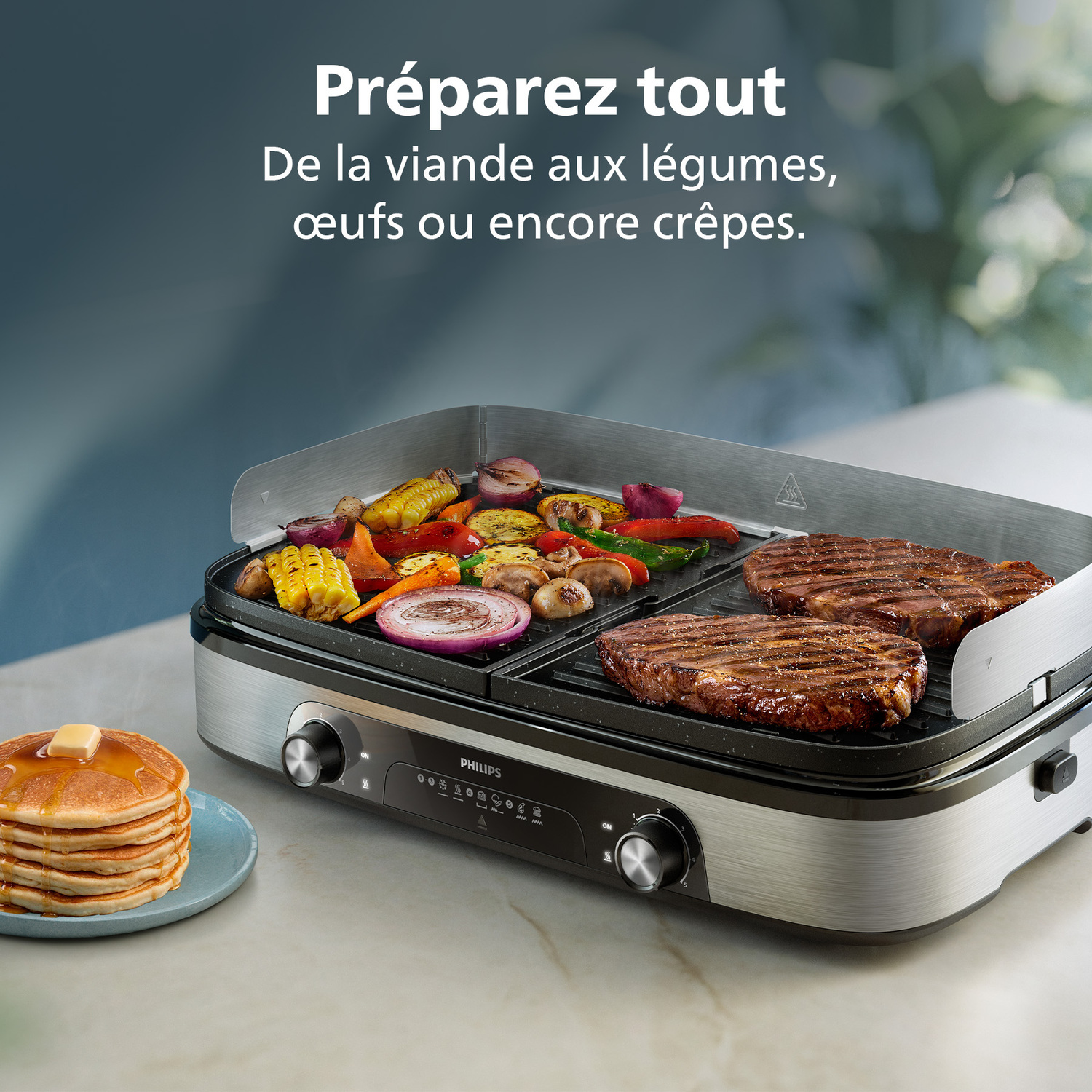 Un grill Philips avec des steaks et des légumes cuits. Des crêpes sont à gauche. Le texte dit 'Préparez tout', en français.