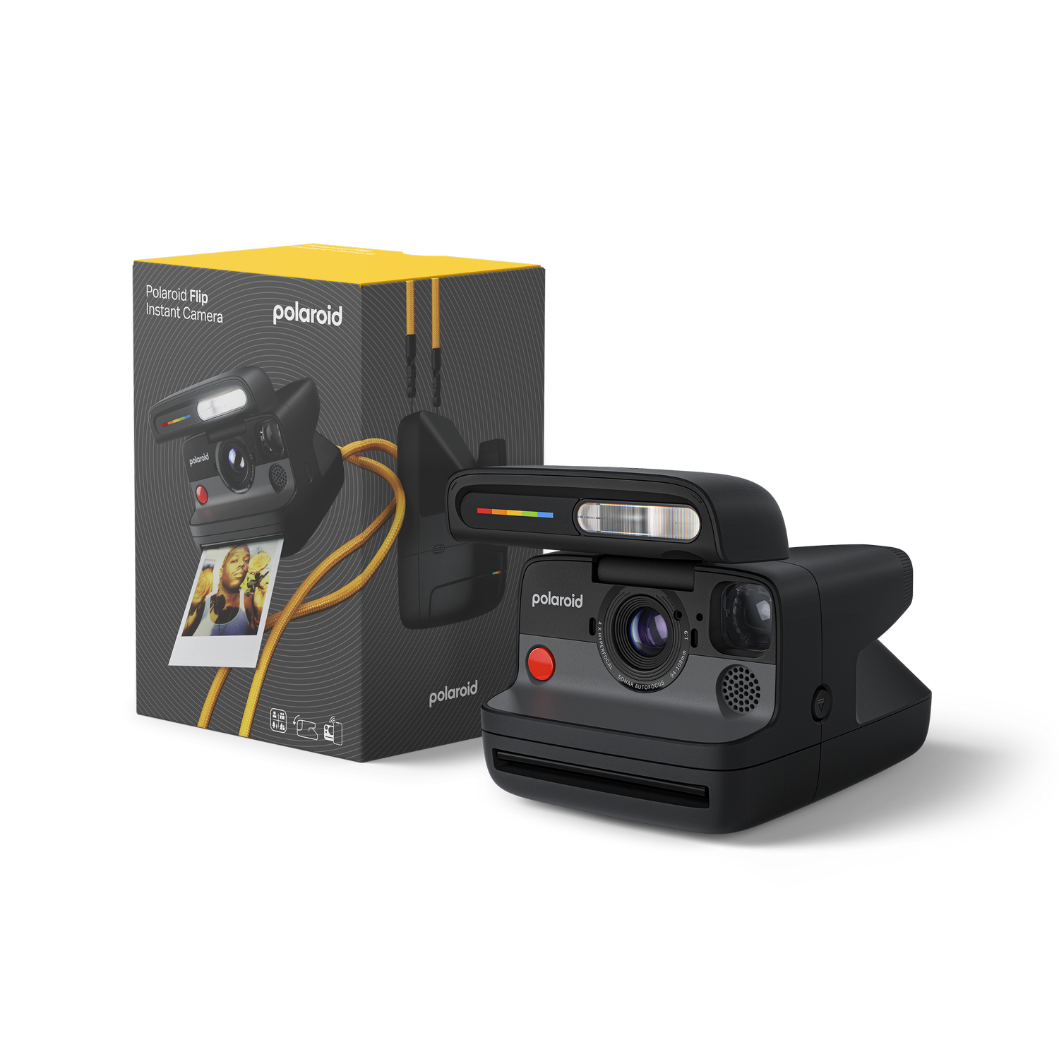 Cámara Polaroid y caja. La cámara es negra con un botón rojo. La caja tiene detalles amarillos.
