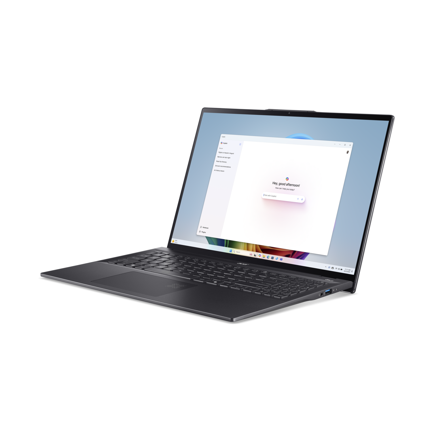 Laptop open on a black surface, screen showing a website. Dark grey color.