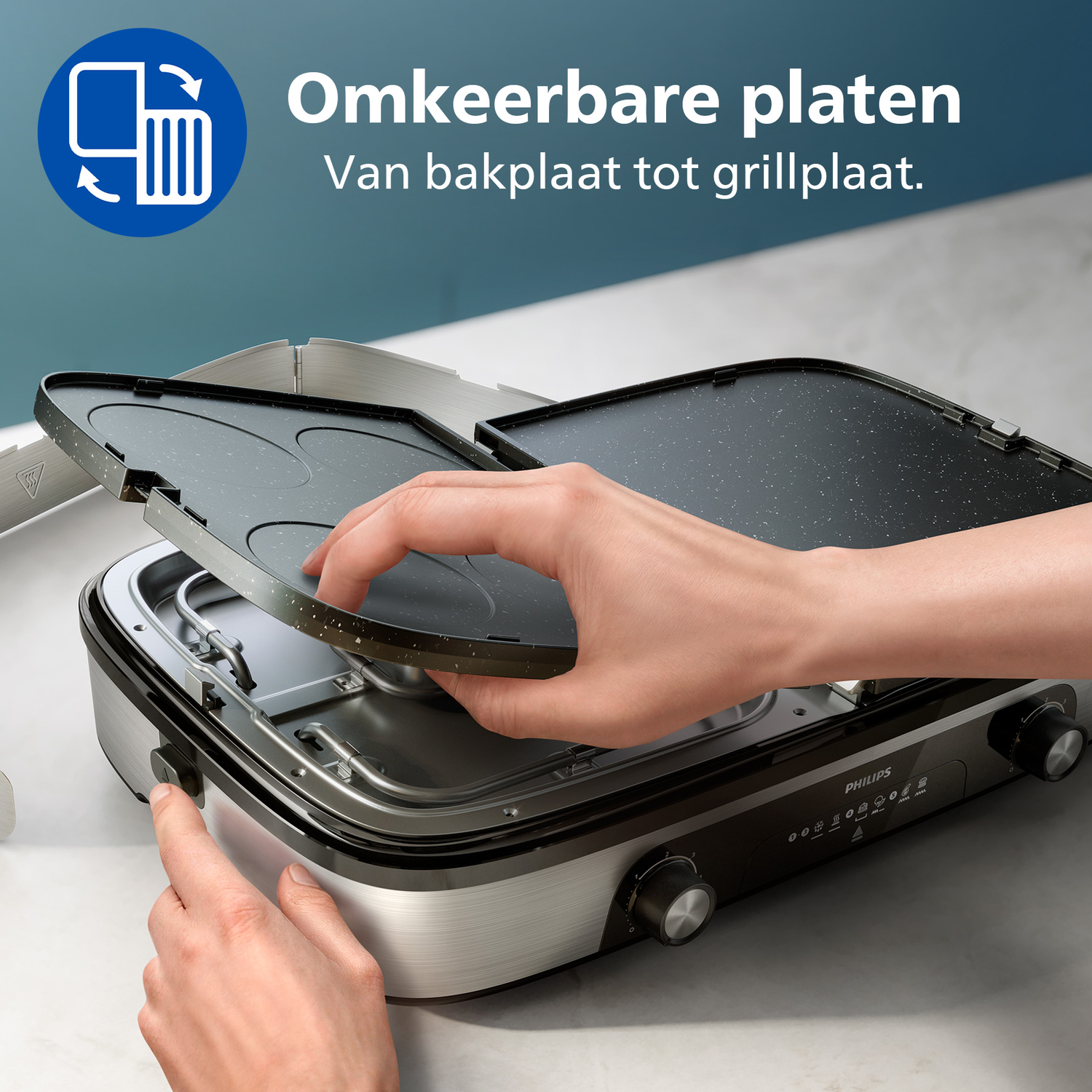 A person is using a Philips reversible grill. The person's hands are manipulating the grill plates. The background is blue and white.