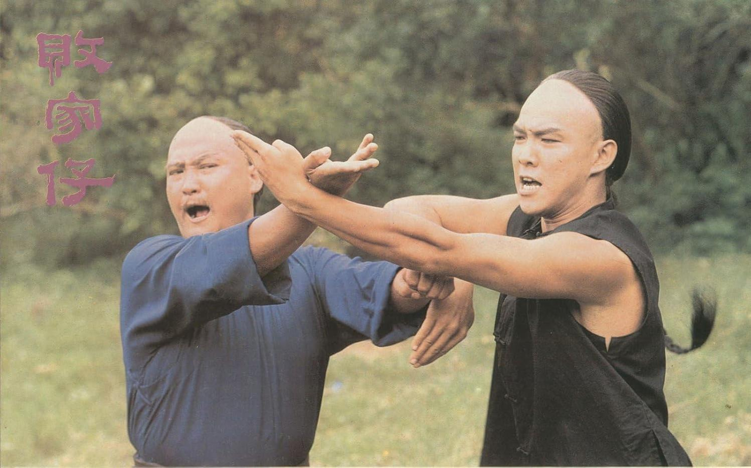 Zwei Männer in traditioneller Kleidung üben Kampfsport.