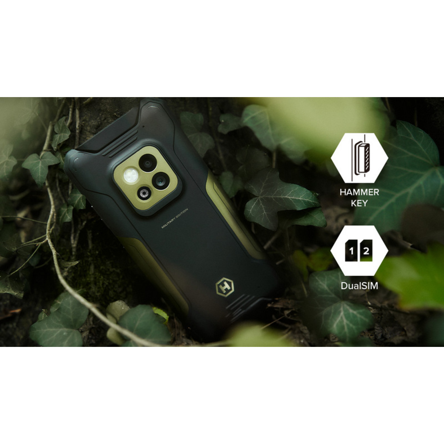 A rugged smartphone, black and olive green, rests among green leaves. Icons indicate a hammer key and dual SIM functionality.