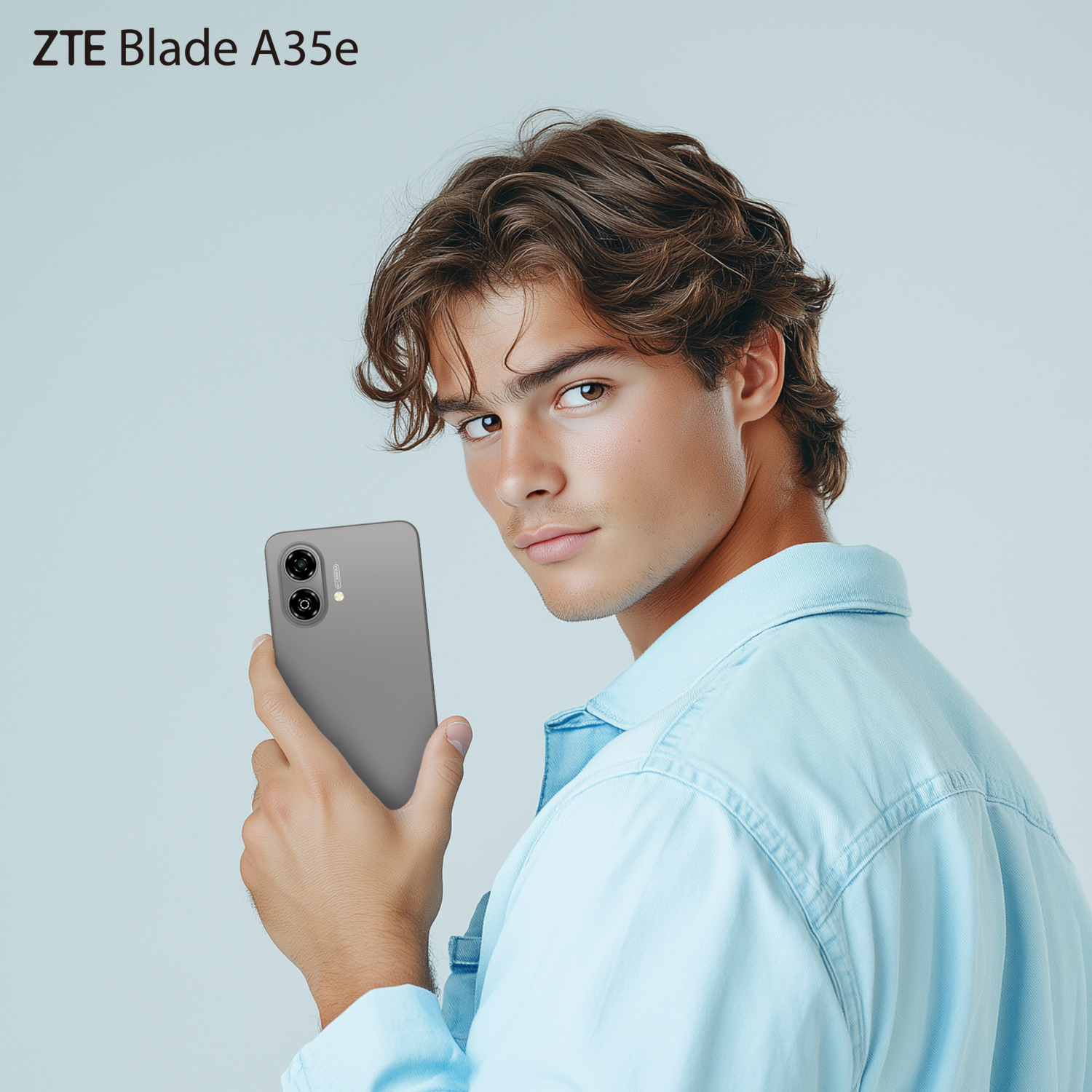 A man holding a gray phone, with the text ZTE Blade A35e.