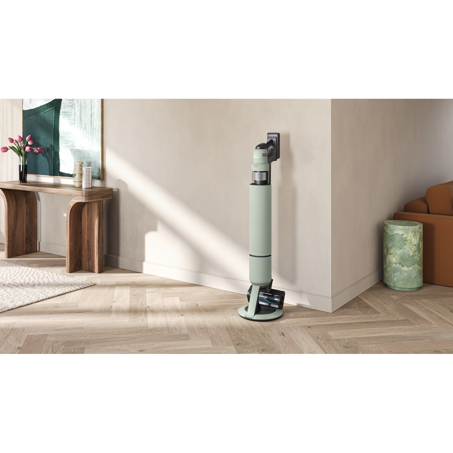 Robot vacuum cleaner leaning against a wall. Interior with light wood floor and artwork.