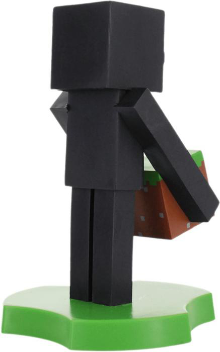 Eine Minecraft Enderman-Figur mit einem schwarzen, blockartigen Körper, der einen Erdblock auf einem grünen Sockel hält.