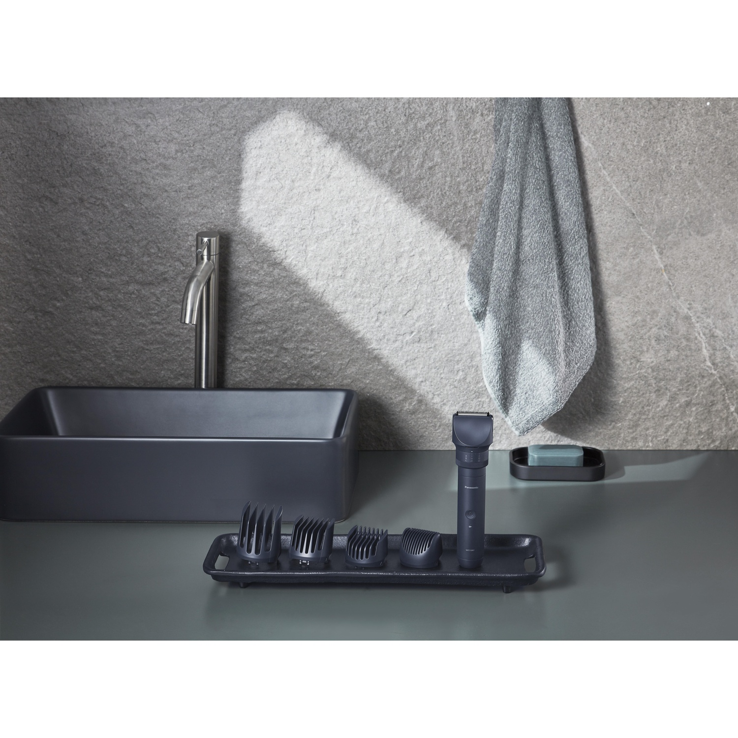 Bagno moderno con lavandino, rubinetto e strumenti per la toelettatura. Asciugamano.