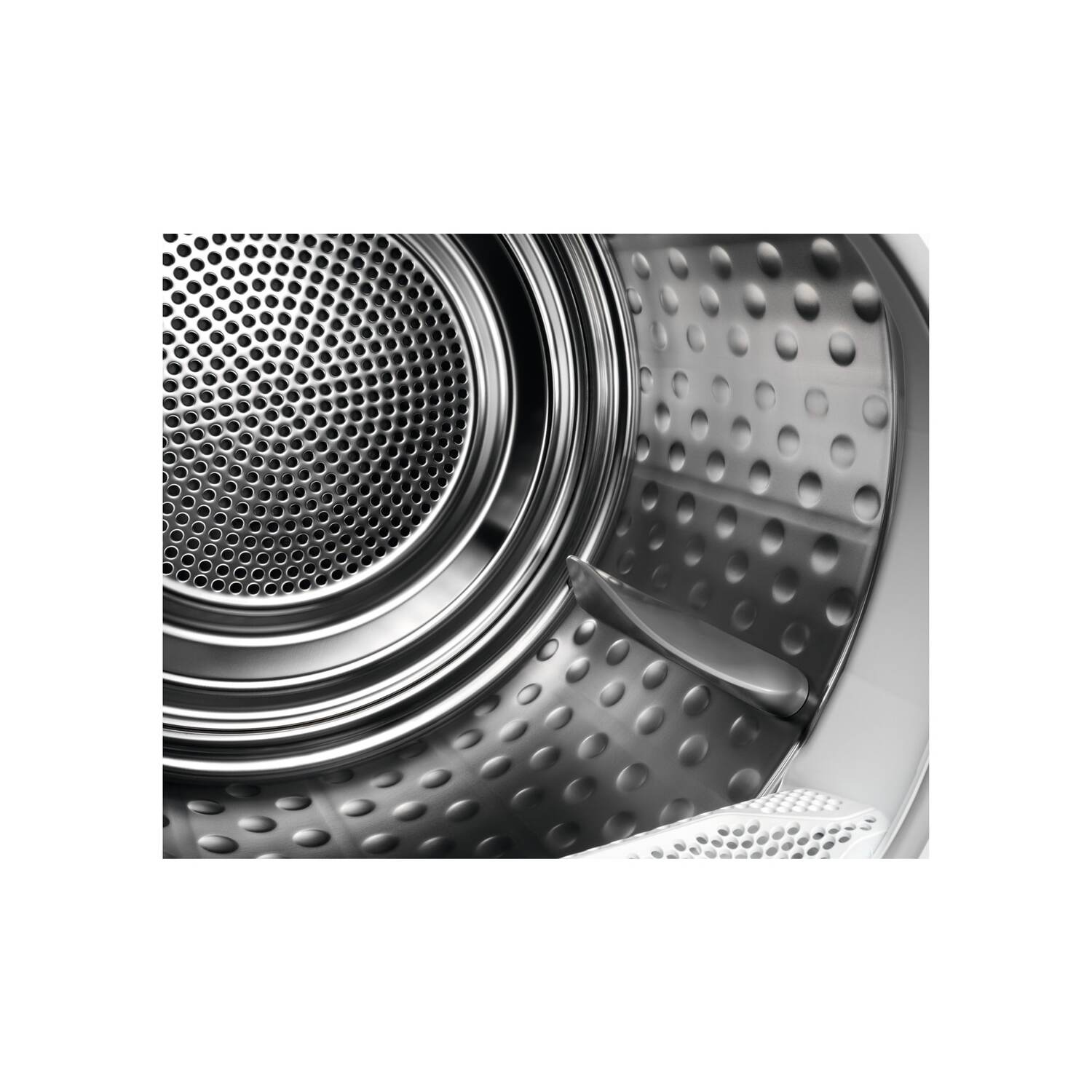 Close-up of the interior of a washing machine drum, with perforated metal and metal parts.
